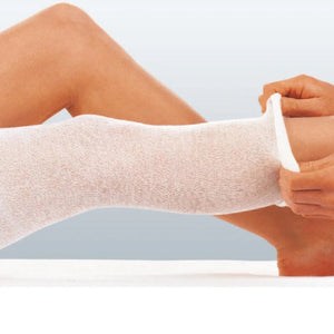 tricofix tubular mesh bandage being placed onto the leg calf