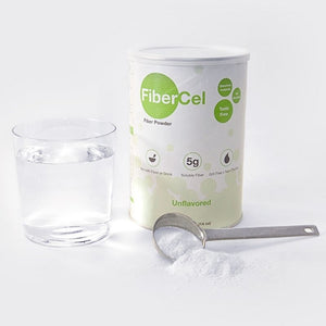 Global Health Fiberbel fiber powder in a can, next to a glass of water