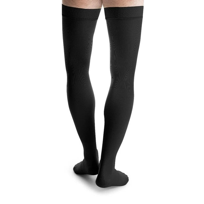 man wearing jobst formen thigh high compression sock closed toe in black, back view