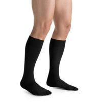 man wearing jobst formen casual knee high compression sock closed toe in black, right view
