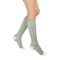 leg wearing medi rejuva high knee compression sock in heart sage cream colour, side view