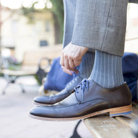 person wearing medi rejuva high knee compression sock in herringbone charcoal colour