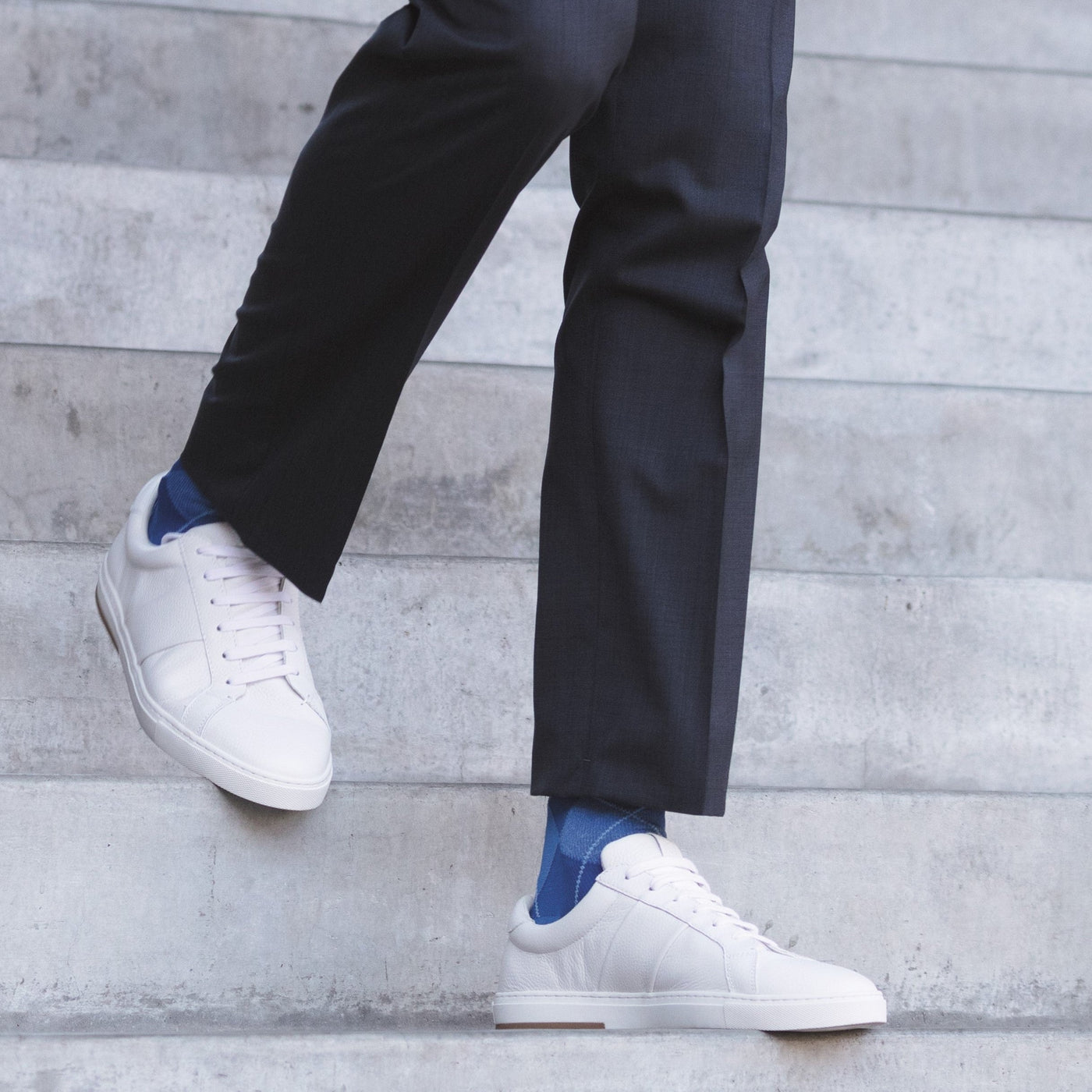 men walking down the stairs wearing the sigvaris microfibre patterns sock in royal blue argyle