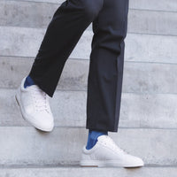 men walking down the stairs wearing the sigvaris microfibre patterns sock in royal blue argyle