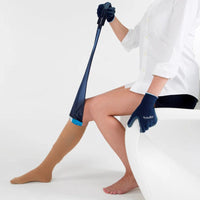 person removing the sigvaris magnide donning aid from under a compression stocking while wearing a donning glove