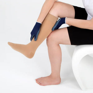 person sitting on a chair using the sigvaris textile donning gloves to put on compression sock