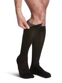 man wearing sigvaris microfibre knee-high compression sock in black, showing the silicone dotted band inside.