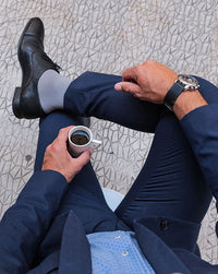 man in a blue suit wearing sigvaris steel grey mcirofibre compression sock