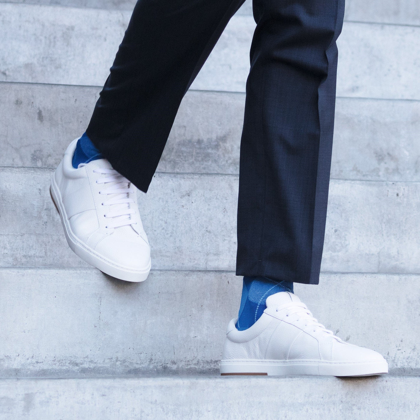 men walking down the stairs wearing the sigvaris microfibre patterns sock in royal blue argyle