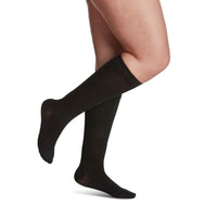side view of closed toe soft opaque black knee high compression socks