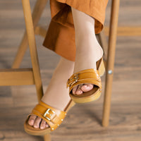 woman wearing light beige sigvaris opaque open toe knee high compression sock with sandals and wide-leg pants