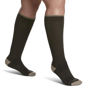 close-up of a leg wearing sigvaris merino wool outdoor compression sock in olive colour, side view.